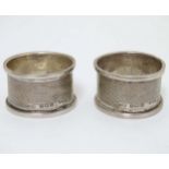 A pair of silver napkin rings with engine turned decoration hallmarked Birmingham 1940 maker Lanson