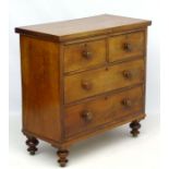 A late 19thC mahogany chest of drawers comprising two short over two long drawers,