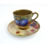 A Royal Worcester demi-tasse cup and saucer, with painted fruit design by W H Austin,