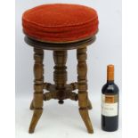 A Victorian mahogany piano stool standing on ring turned legs,