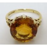 A mid 20thC 18ct gold ring set with facet cut citrine.