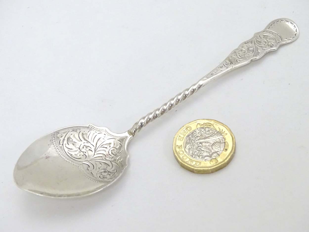 A silver preserve spoon with engraved decoration hallmarked Birmingham 1906 maker William