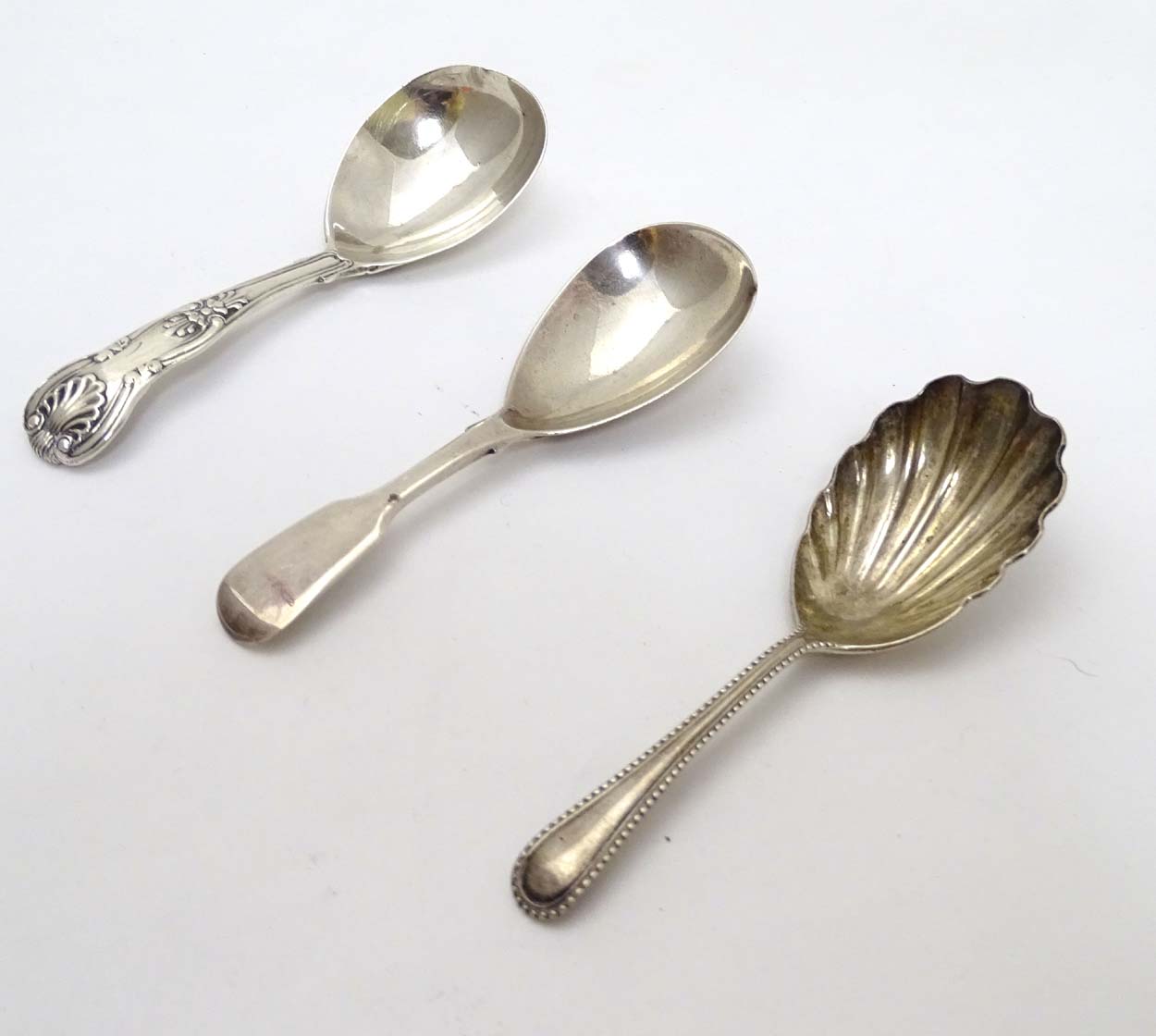 Three silver caddy spoons one hallmarked London 1893 maker Robert Stebbings with shell formed bowl,