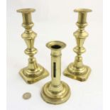 A pair of 19thC brass ejector candlesticks 8 1/2" high. Together with another 6" high.