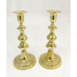 A pair of early 19thC spun brass candlesticks with ejectors.