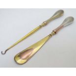 Silver handled button hook and shoe horn with engine turned decoration and traces of gilding.