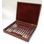 A cased 6-place set of silver plated fruit knives and forks.