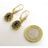 A pair of gold drop earrings set with blue and white stones 1 1/4" long CONDITION: