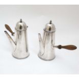 A white metal cafe au lait set with turned wooden handles.