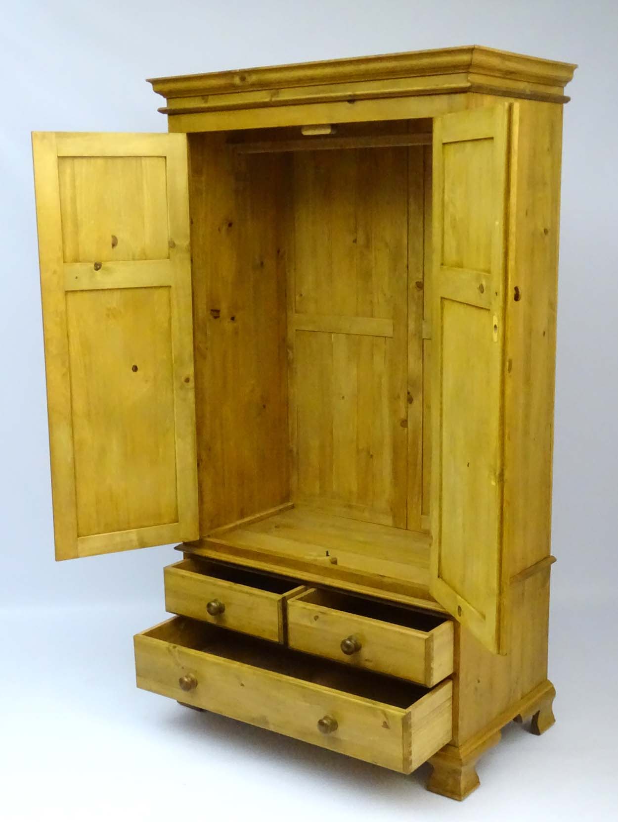 A mid / late 20thC pine wardrobe with an ovolo moulded top above two doors containing storage space - Image 5 of 9