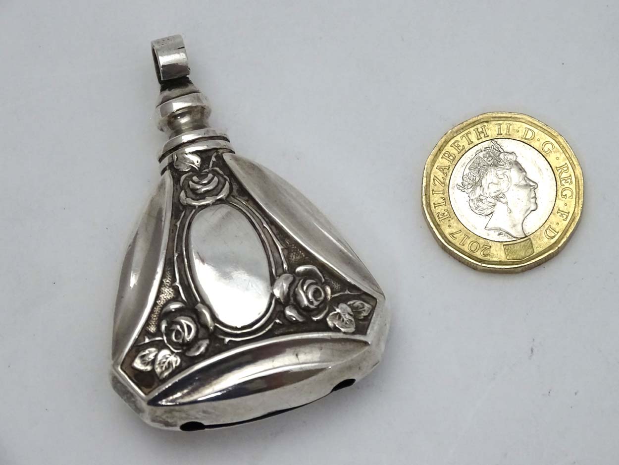 A Continental 800 silver pendant rattle with rose decoration 2 1/4" long CONDITION: