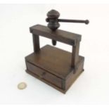 A 19thC oak miniature printing press / book brass with drawer under.