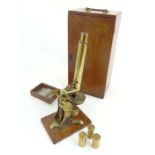 A mahogany boxed monocular microscope marked ' Baker 244 High Holborn London ' having spare lens