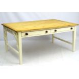 An early 20thC extending pine kitchen table, with painted base containing two long drawers,