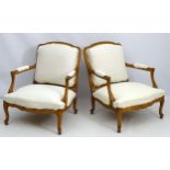 A pair of early 20thC large Louis XV style walnut open armchairs,