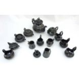 A collection of 14 items of black basalt ware ceramics to include , tea plate , jugs,