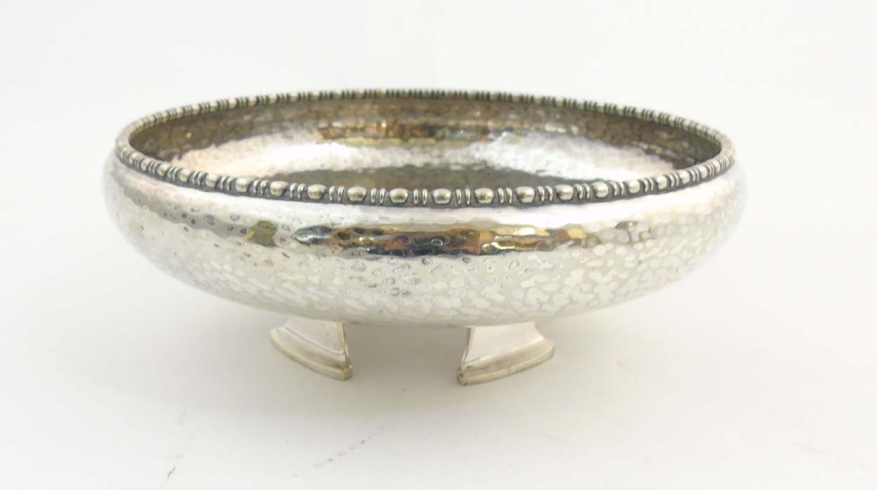 Arts and Crafts : A four foot hammered silver plate bowl by J B Chatterly & Sons ltd. Marked under.