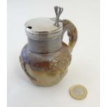 A 19thC stoneware salt glazed harvestware jug, with reliefs depicting a windmill, tree and another,