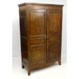 An early / mid 19thC mahogany Guernsey press / wardrobe, with panelled sides and doors,