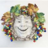 An Italian majolica Bacchus mask wall hanging in the style of Apolito per Cottura,