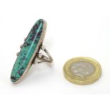 Native American jewellery : A white metal ring set with large turquoise hardstone cabochon.