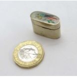 A silver plate small pill box of ovoid form with image to top of a kookaburra bird 3/4" high