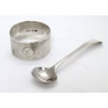 A silver napkin ring with engine turned decoration hallmarked Birmingham 1917 maker T H Hazlewood &