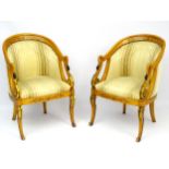 A pair of mid / late 20thC maple Empire style swan tub chairs with gilt scrolling and marquetry