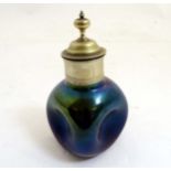 Arts & Crafts : an iridescent glass and silverplate bottle having indented sides and cork stopper ,