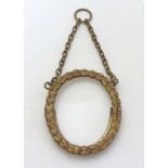 A circa 1900 small oval Victorian brass frame with oval glass and hanging chain ,