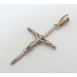 A silver crucifix pendant. 1 1/2" long Prov: Formerly from the Toni Parks UK Collection.