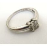 A platinum (950) ring set with 4 diamonds in a squared setting CONDITION: Please