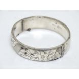 A hallmarked silver bracelet of bangle form with engraved decoration CONDITION: