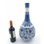A Chinese blue and white pear shaped vase with bulbous body and tall cylindrical neck ,