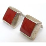 A pair of Mexican silver clip earrings of squared form with red decoration.