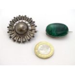 An oval white brooch set with malachite cabochon 1" wide,