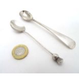 A silver teaspoon, the handle surmounted by thistle decoration,