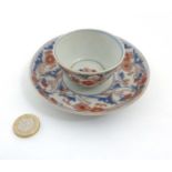 A Japanese Imari cup and saucer,