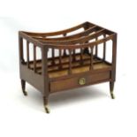 A Regency mahogany three division Canterbury with concave top rails and a single short drawer with