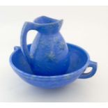A Brannam Barnstaple pottery wash bowl and jug decorated in a light blue colour with green mottled