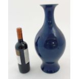 A Chinese blue monochrome vase with round bulbous body on flared foot / base,