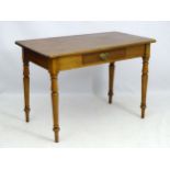 An early / mid 19thC side table / writing table, standing on turned legs terminating in arrow feet,