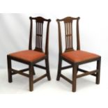 A pair of mid 18thC mahogany side chairs with shaped cresting rail and pierced back splat,
