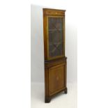 An Edwardian mahogany corner cupboard with marquetry inlay to the frieze and base, having two doors,