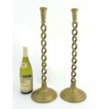 A pair of c.1900 tall brass double open-twist candlesticks on circular bases.