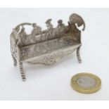 A Continental silver miniature / dolls house bench / settee decorated with various figures marked