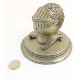 A nickel desk stand in the form of a knight's helmet,