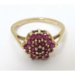 A 9ct gold ring set with red stone cluster CONDITION: Please Note - we do not make