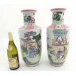 A pair of Famille Rose Rouleau vases,