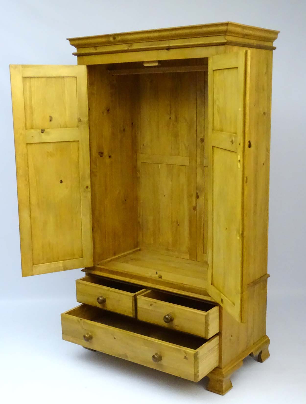 A mid / late 20thC pine wardrobe with an ovolo moulded top above two doors containing storage space - Image 4 of 9